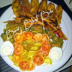 Indian green flour balls, grilled plantain curry rolled potatoes, glazed spicy carrots strips A picture of Indian green flour balls, grilled plantain curry rolled potatoes, glazed spicy carrots strips.