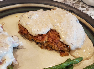 A picture of Classic Country Chicken Fried Steak with white gravy.