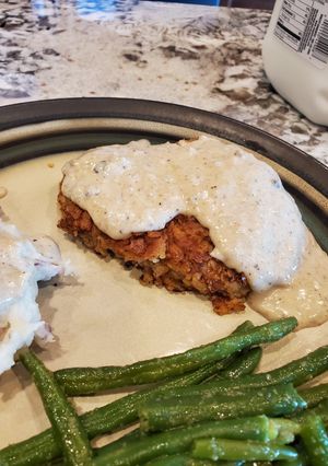 A picture of Classic Country Chicken Fried Steak with white gravy.
