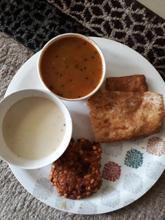 A picture of Dal vada, dosa with chutney and sambhar.