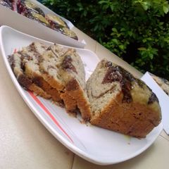 A picture of Chocolate x citrus banana swirl loaf with citrus glaze.