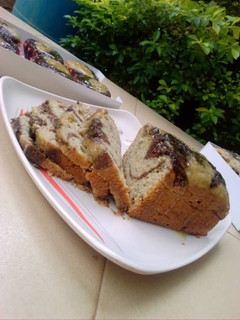 A picture of Chocolate x citrus banana swirl loaf with citrus glaze.