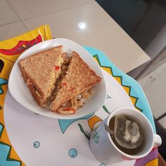 Sandwich + scrambled eggs + green tea A picture of Sandwich + scrambled eggs + green tea.
