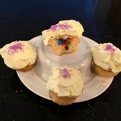 A picture of Surprise Vanilla Cupcakes with White Chcolate Cream Frosting.