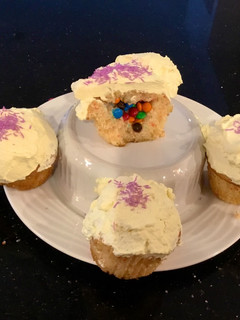 A picture of Surprise Vanilla Cupcakes with White Chcolate Cream Frosting.