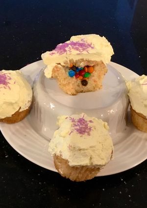A picture of Surprise Vanilla Cupcakes with White Chcolate Cream Frosting.