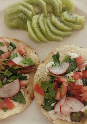 A picture of Cheesy Mushroom and Spinach Tostadas with Mexican Salad.