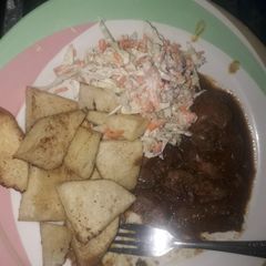 A picture of Yam with liver sauce and coleslaw.