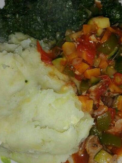 A picture of Mashed potatoes with beef stew and vegetables.