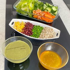 A picture of Mini Salad Bar With Avocado Dressing & Honey Dressing.