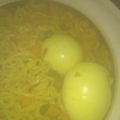 A picture of Watery veggies noodles with boiled eggs.