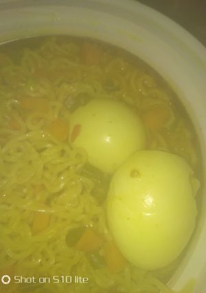 A picture of Watery veggies noodles with boiled eggs.
