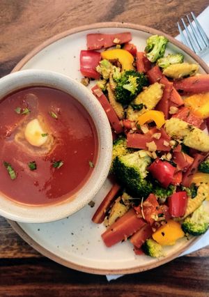 A picture of Tomato Soup with sauteed garlic vegetables.