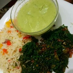 A picture of Vegetable rice Served with spinach and brocolli soup.