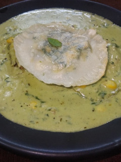 A picture of Ravioli in pesto sauce.