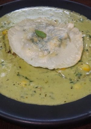 A picture of Ravioli in pesto sauce.