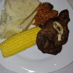 A picture of Grilled beef chops with carrot salad.