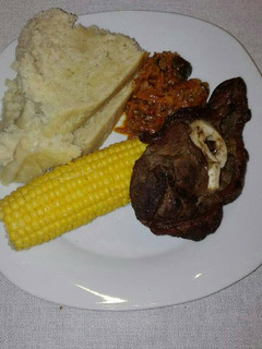A picture of Grilled beef chops with carrot salad.