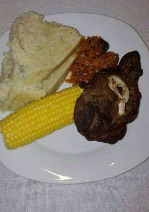A picture of Grilled beef chops with carrot salad.