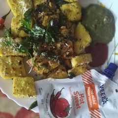 A picture of Chulbuli chilli chutney n red hot n sweet 🍅🌶️ sauce,wth dhokla.
