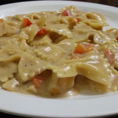 A picture of Bowties with veggies in creamy sauce.