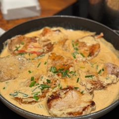 A picture of Pork medallions with creamy sauce.