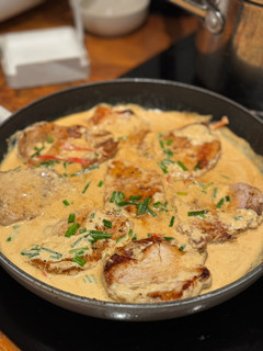 A picture of Pork medallions with creamy sauce.