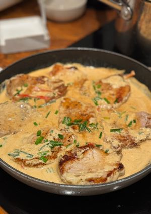 A picture of Pork medallions with creamy sauce.