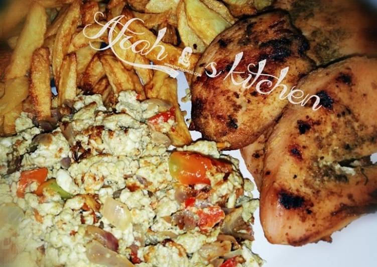 Fried potatoes,scrambled egg and roasted chicken