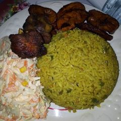 A picture of Fried Rice, Vegetable Salad, Turkey with Fried Plantain.