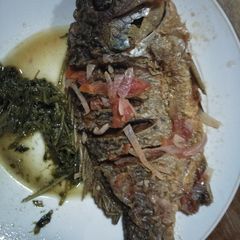 A picture of Stewed fish with greens.