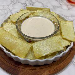 A picture of Yam Chip snack with dip.