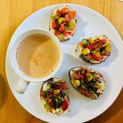 A picture of Hummus & grilled veggies crostini.