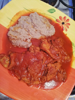 A picture of Huevo refritos con adobo rojo y Frijoles refritos molidos.