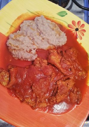 A picture of Refried Eggs with Red Adobo and Mashed Refried Beans.