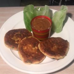 A picture of Fish cake with Cabbage wrapper and Satay sauce.