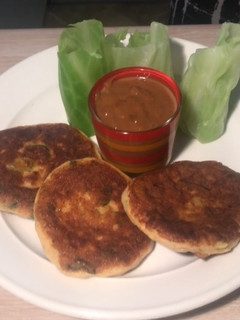 A picture of Fish cake with Cabbage wrapper and Satay sauce.