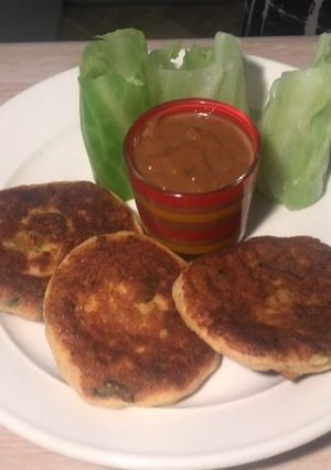 A picture of Fish cake with Cabbage wrapper and Satay sauce.