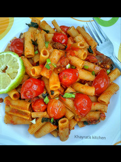 A picture of Basil penne pasta in hot tomato sauce.