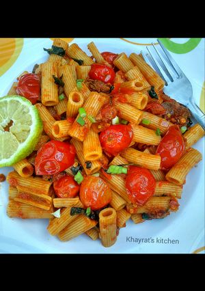 A picture of Basil penne pasta in hot tomato sauce.