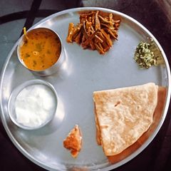 A picture of Traditional Maharashtrian Thali. Amti,Chapati,Thecha, Bhendi,Dahi,Gud, Rice.