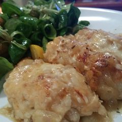 A picture of Chicken fillets with caramalised onion and melted cheese.
