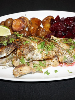 A picture of Griddled sea bass with lime and cilantro butter sauce.