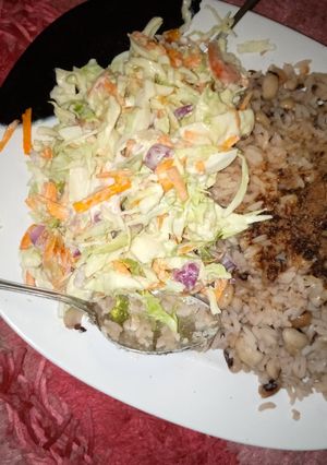 A picture of Rice and beans with coleslaw😋😋😋.