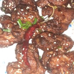 A picture of Chicken wings in schezwan sauce😊.