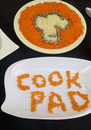 A picture of White and orange rice (cookpad logo).