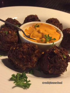 A picture of Crispy Lamb Falafels with chilli cheese sauce.