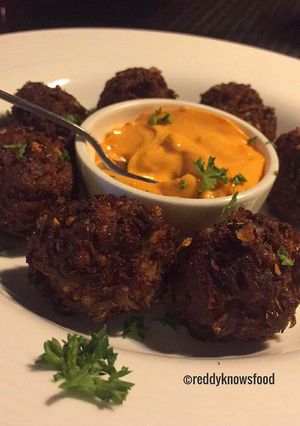 A picture of Crispy Lamb Falafels with chilli cheese sauce.