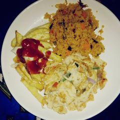 A picture of Couscous with sweet potato chips and fried egg.