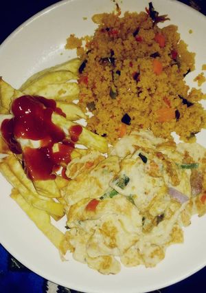 A picture of Couscous with sweet potato chips and fried egg.